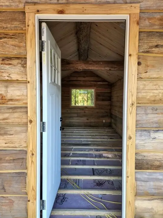 Open entry door looking into a cabin