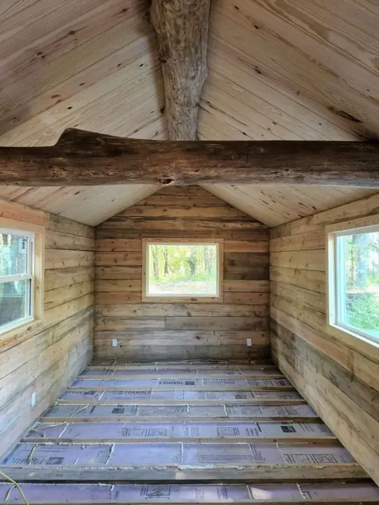 Cabin interior with plank floor and end windows