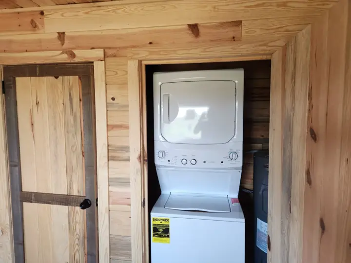 Stacked washer/dryer closet in a solid-log cabin
