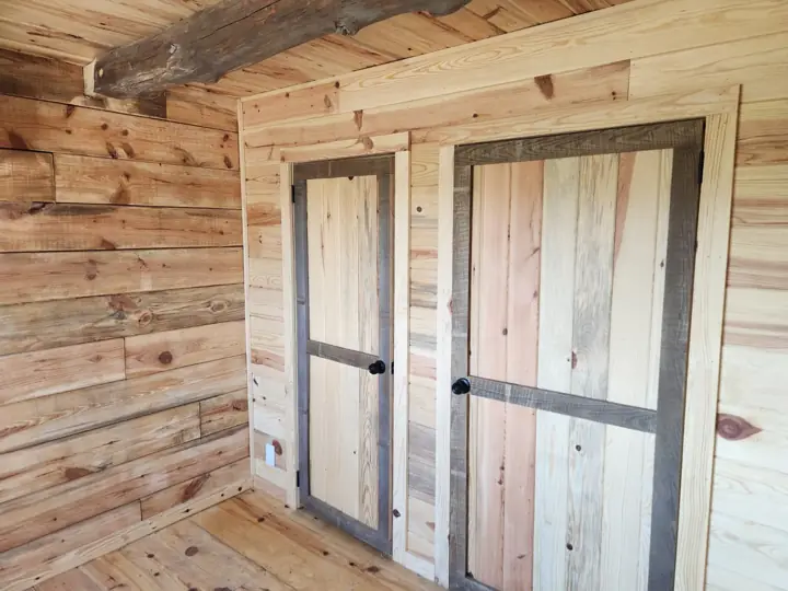 Bath and storage doors along a log wall