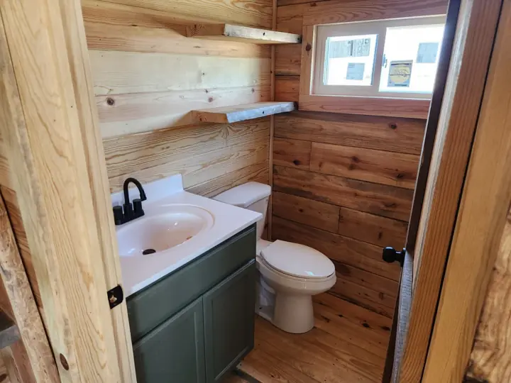 Bathroom vanity and shelving under a window