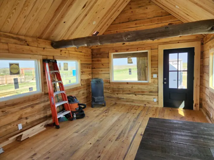 Living area with log ladder and front door