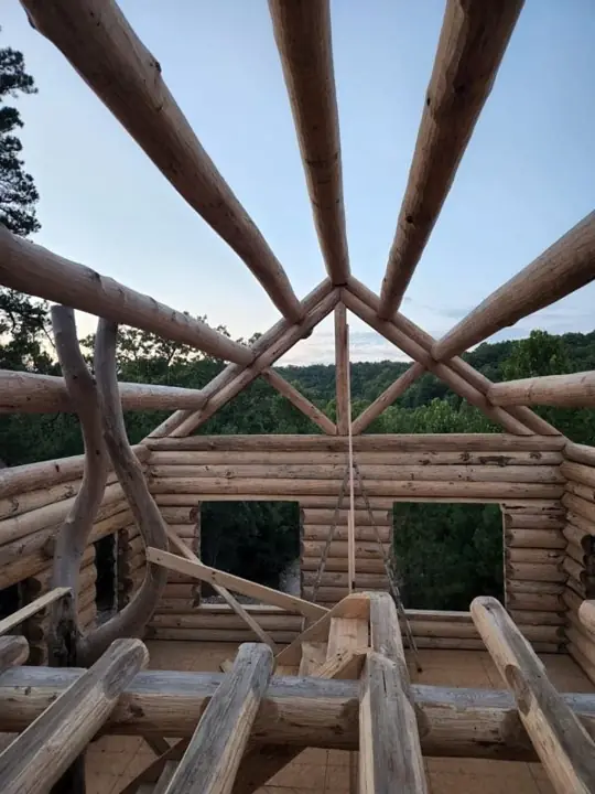 Log roof framing seen from inside a build