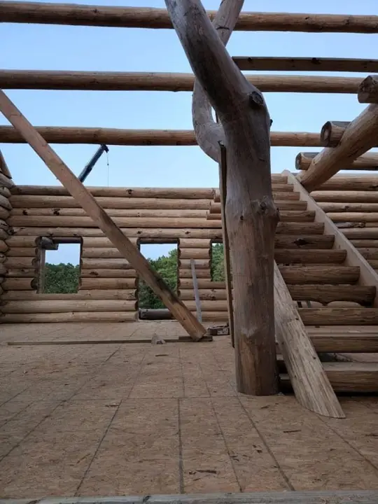 Log stair and roof framing inside a build